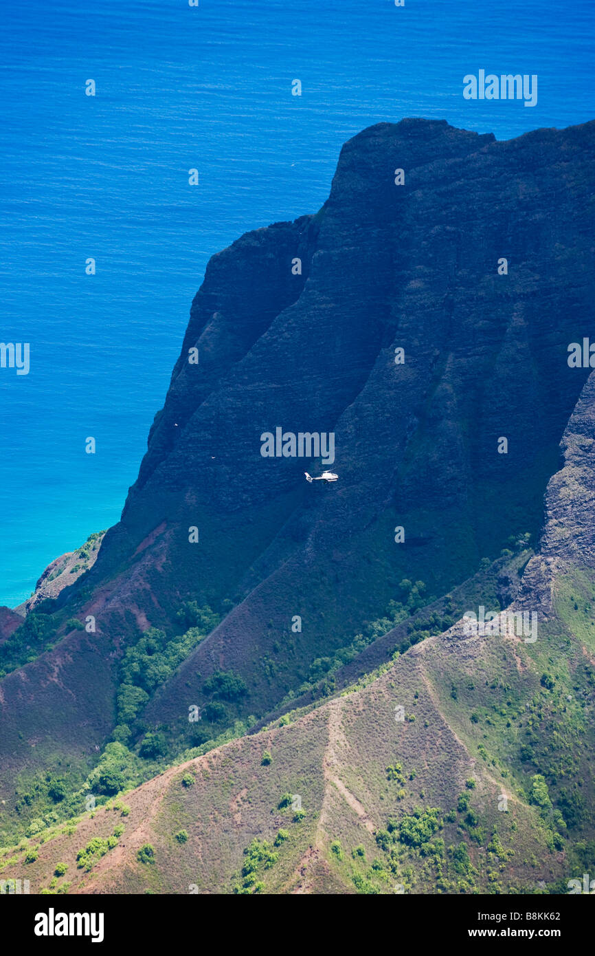 A site seeing helecopter flys above the Kalalau Valley and the Pacific ocean Kauai Hawaii USA Stock Photo
