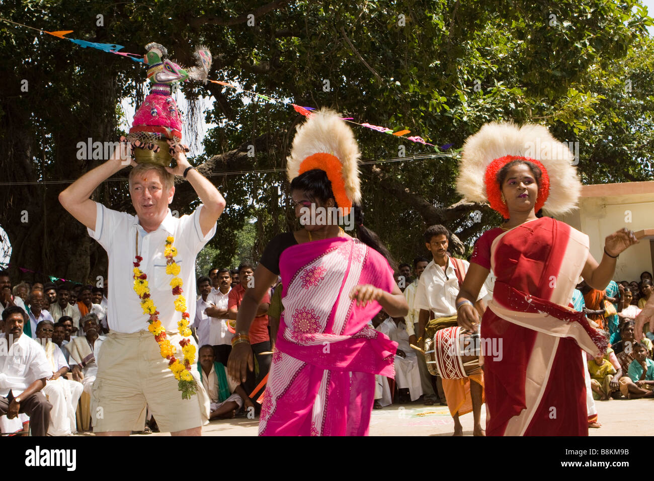 India Tamil Nadu Madurai Tidiyan village pongal celebrations western man dancing with pot on head Stock Photo