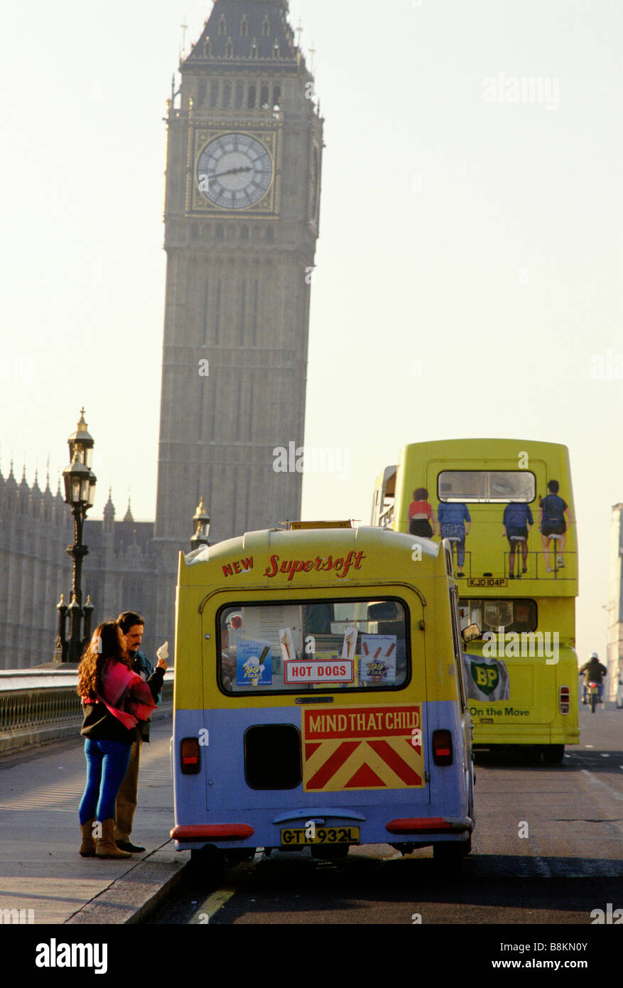 A couple buy ice cream from a passing ice cream van in front of Big Ben, Westminster Bridge,  London,  England, 1997 Stock Photo
