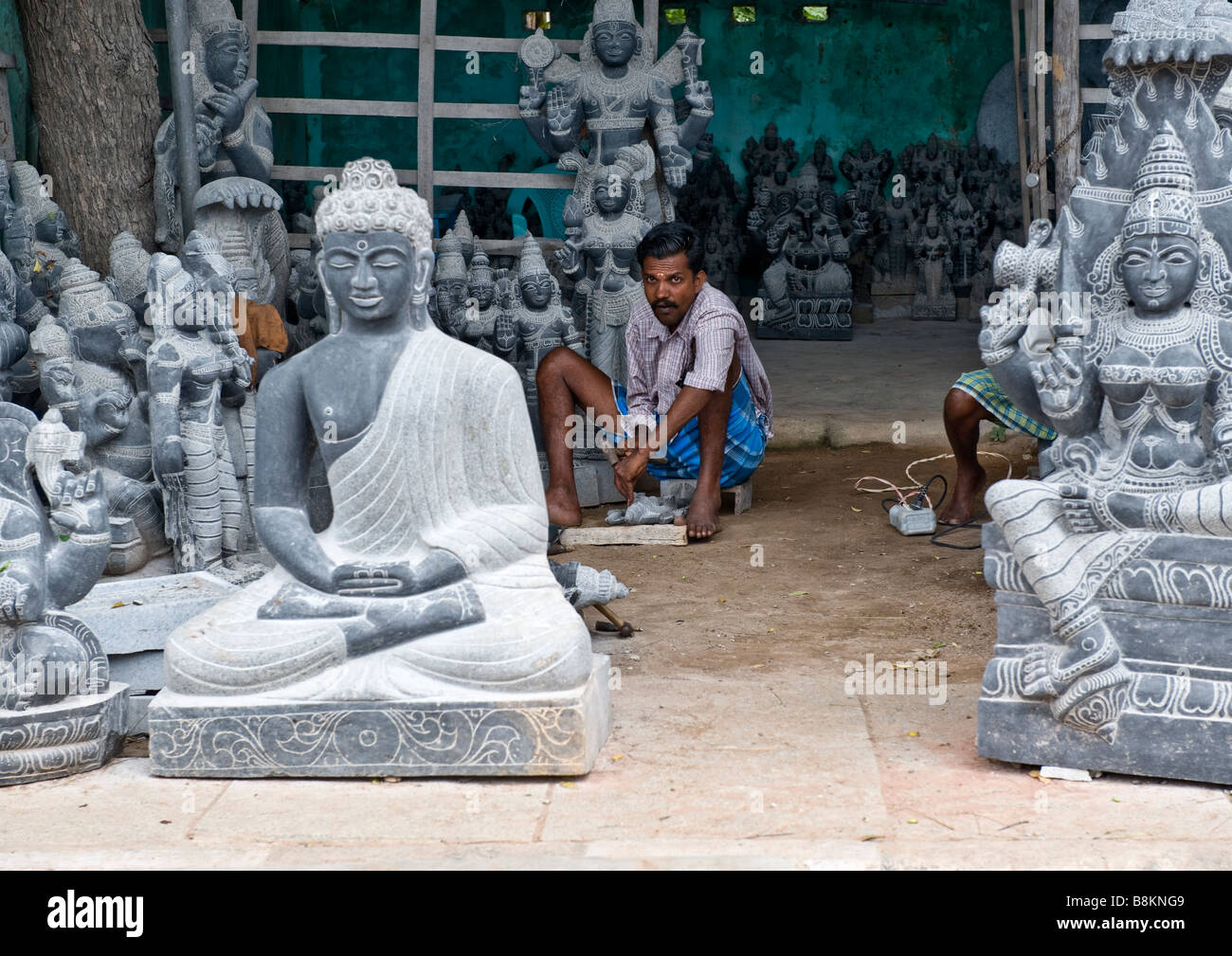 Indian sculptors producing hand carved unique statues of Hindu Gods and Goddesses - each sculpture made from one piece of stone. Stock Photo