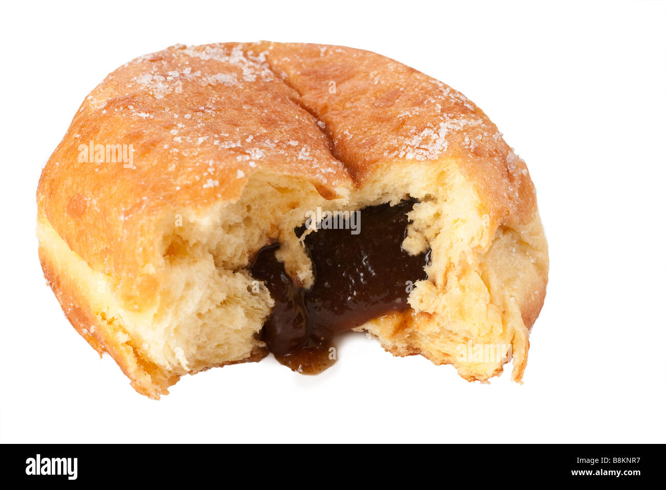 Sugar topped Paczek with the prune filling spilling out Stock Photo