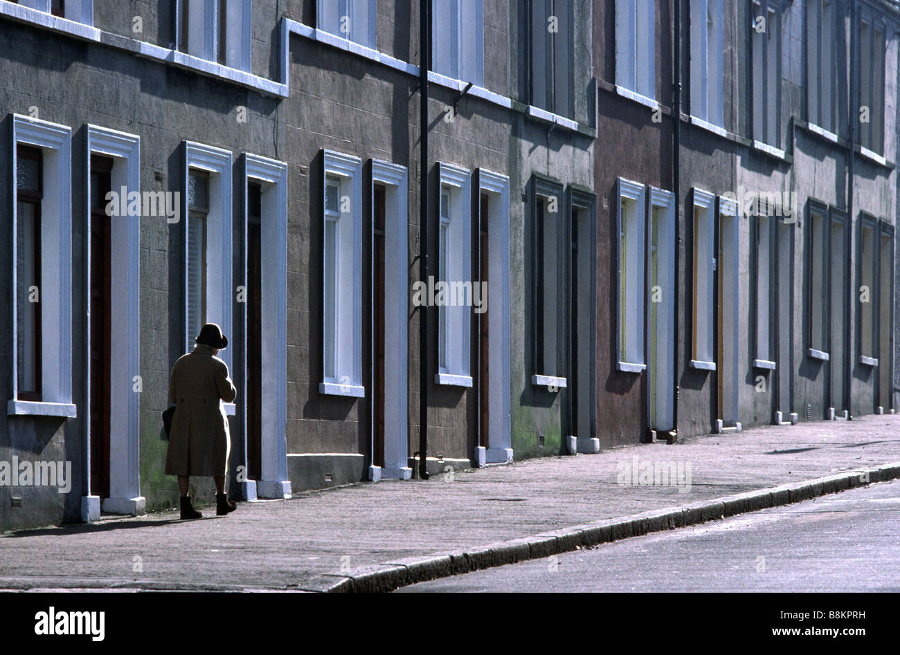 A woman walks past row houses, Belfast, Northern Ireland Stock Photo Alamy