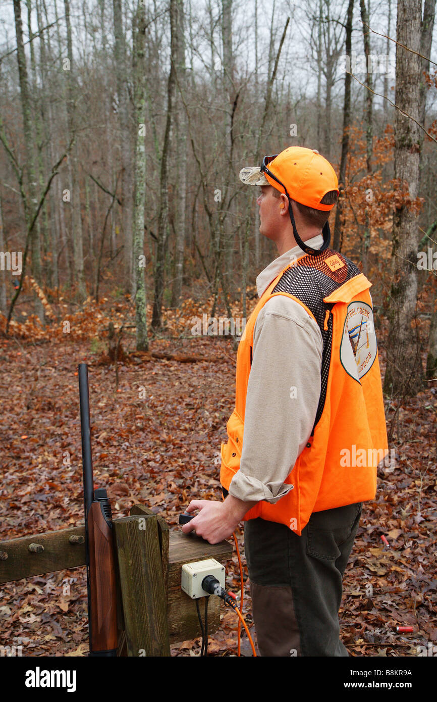 SPORTING CLAY SHOOTER OPERATING ELECTRIC SKEET RELEASE Stock