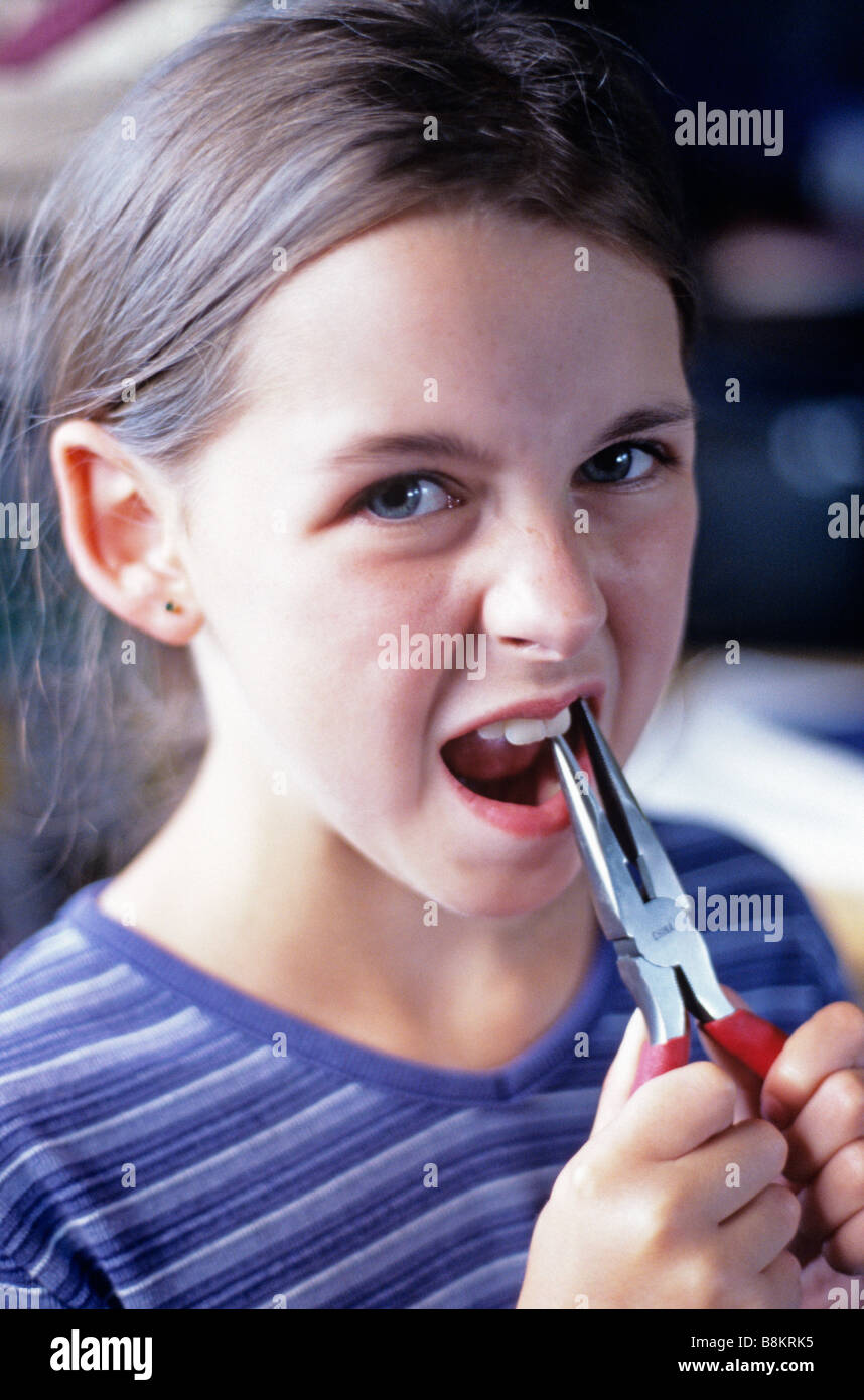 Girl pulling tooth with pliers Stock Photo Alamy