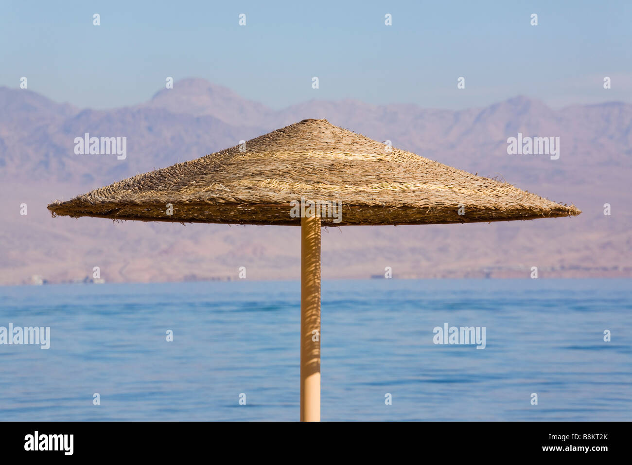 One straw sunshade or sun umbrella on the Red Sea coast. Sinai Egypt Asia Stock Photo