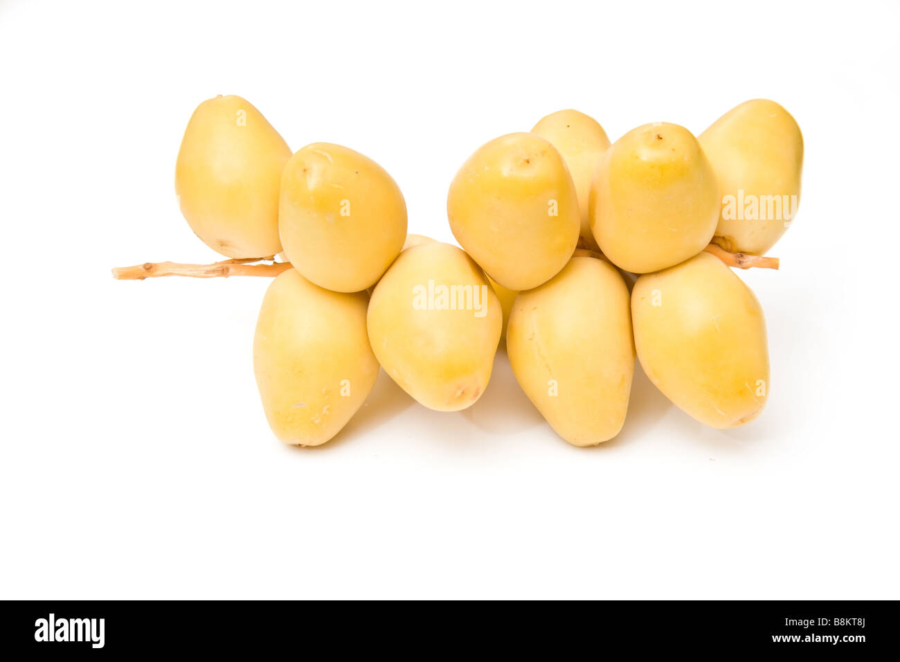 Fresh yellow dates isolated on a white studio background Stock Photo ...