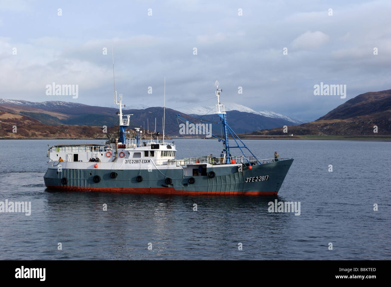 Fishing boat leaving Ullapool Harbour into Loch Broom Stock Photo