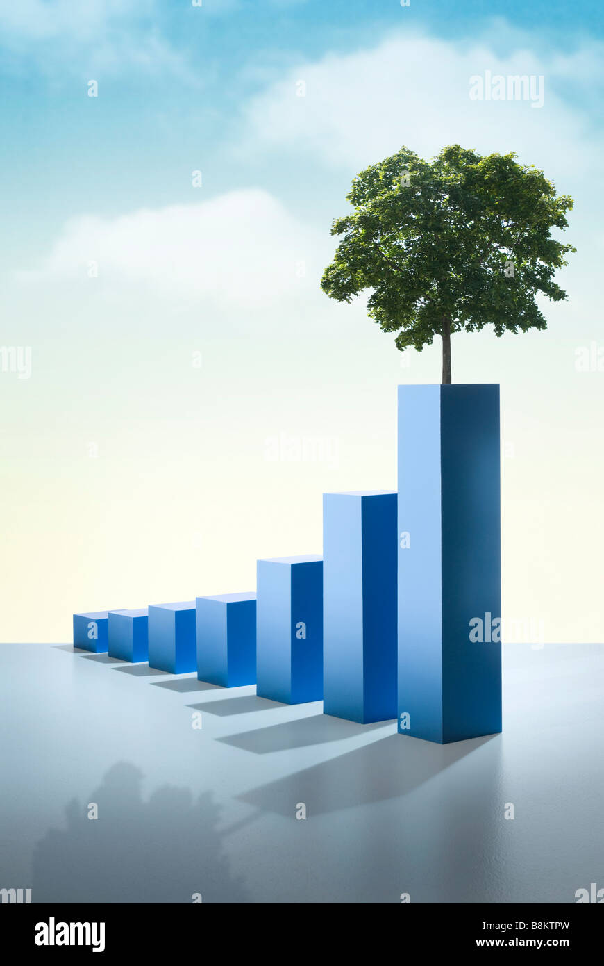 Hand crafted painted wood bar graph with tree image showing an upward trend Stock Photo
