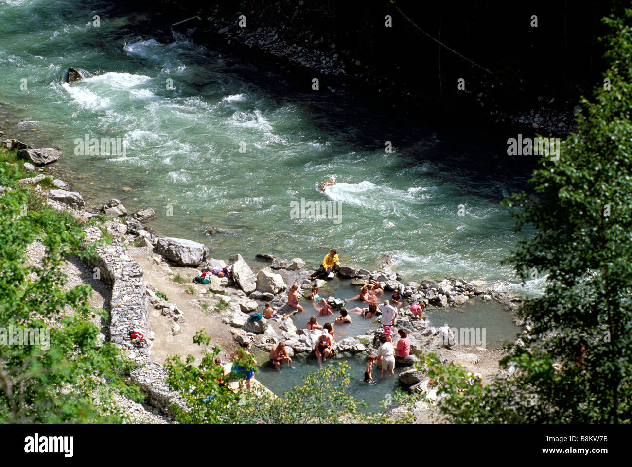 People soaking in Lussier Hot Springs beside the Lussier River in Whiteswan Lake Provincial Park British Columbia Canada Stock Photo
