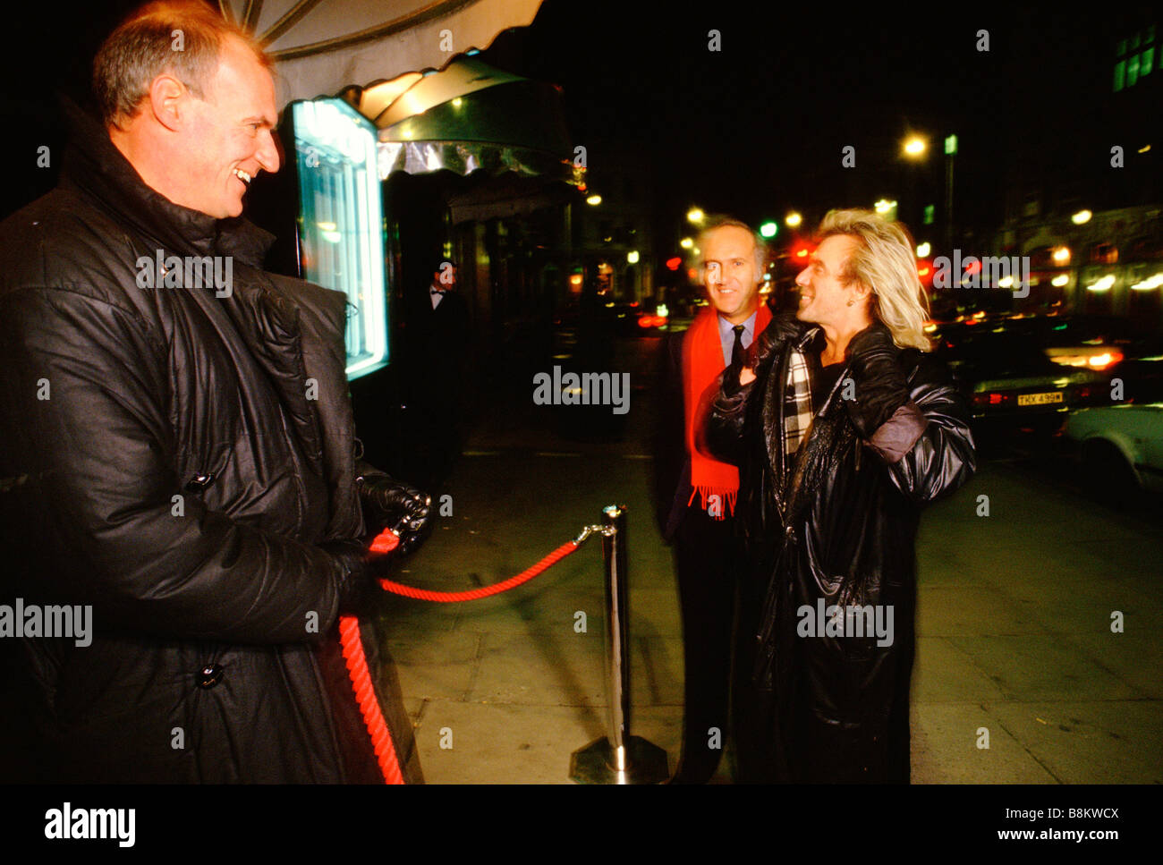 London UK Peter Stringfellow's nightclub - Peter Stringfellow arrives at his club greeted by the doorman. Stock Photo