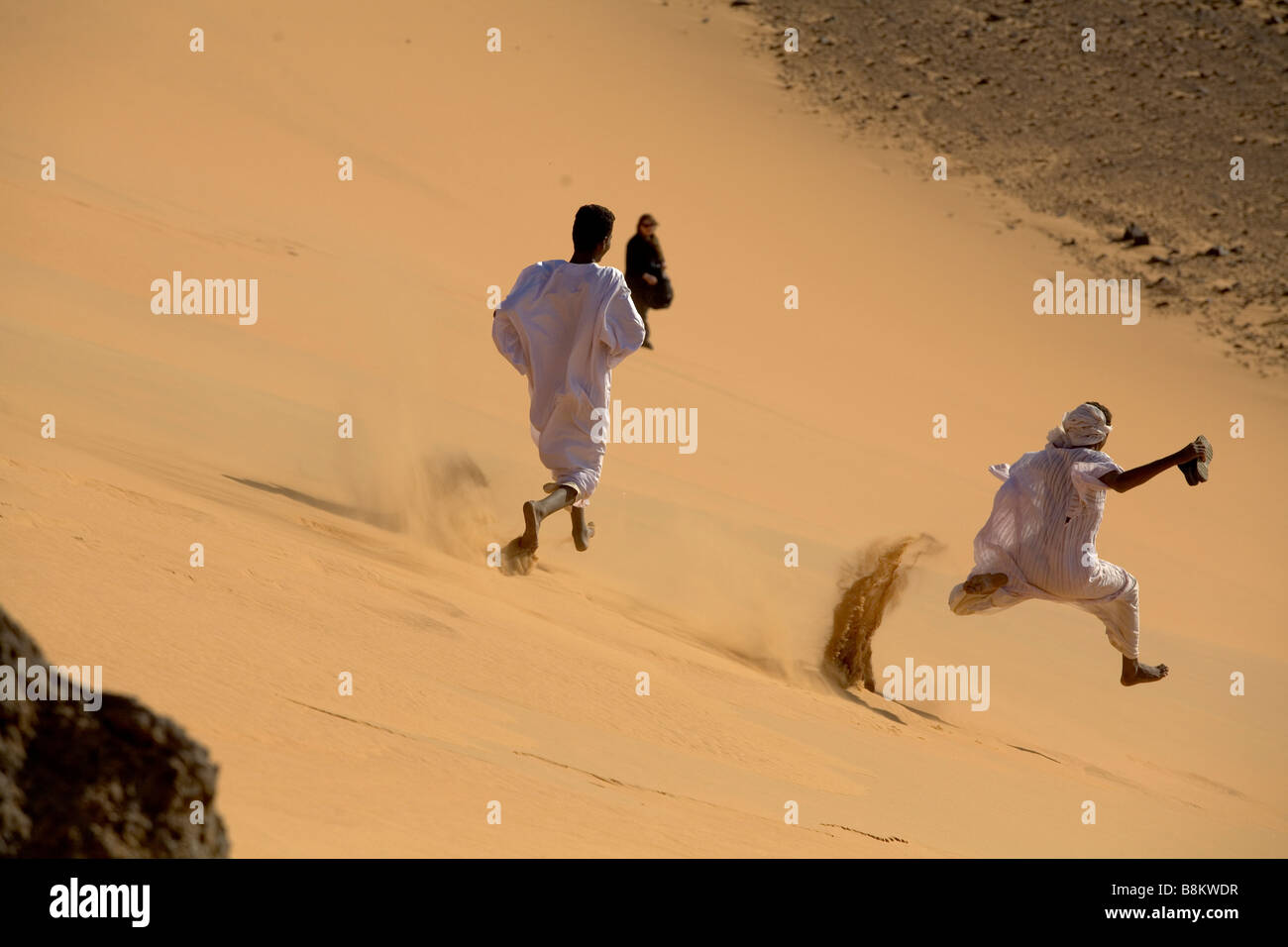 Camel bedouins working and playing near Banganarti, Nubia, Sudan Stock Photo