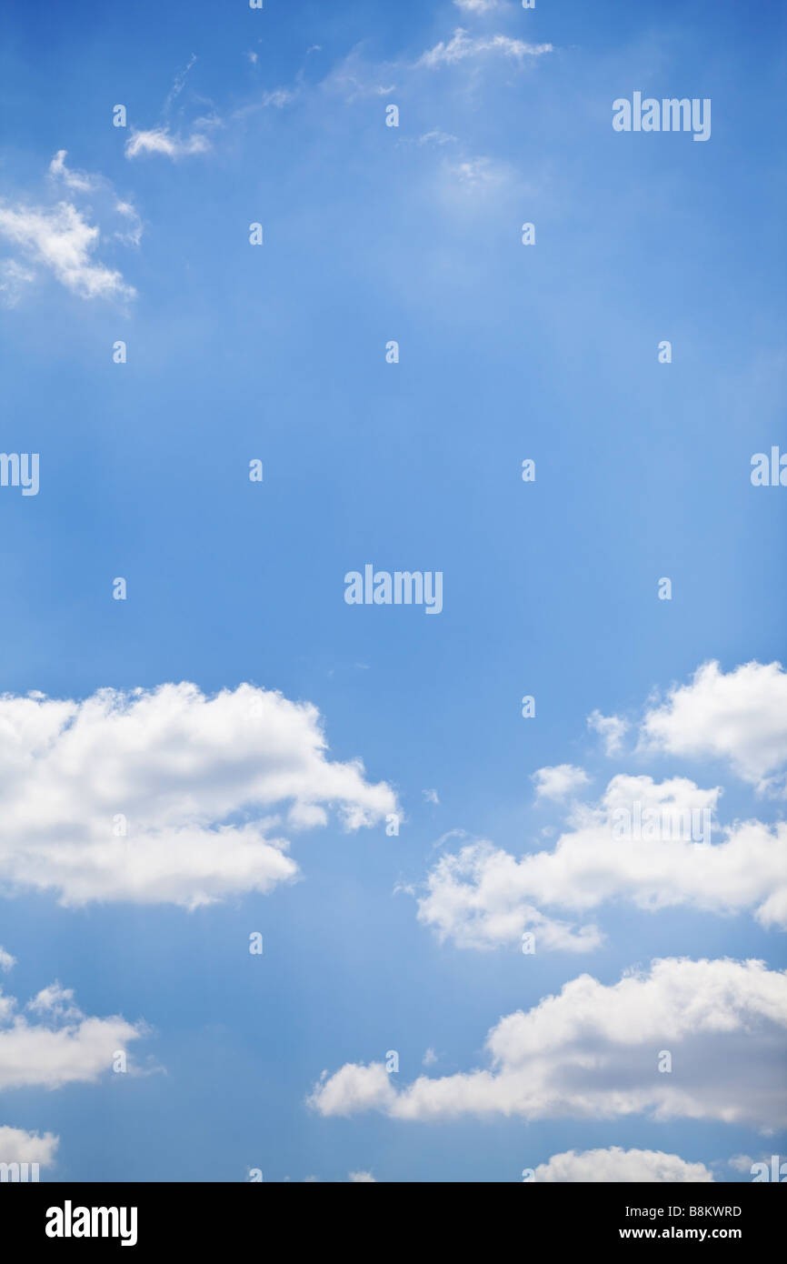 blue sky with white fluffy clouds background Stock Photo - Alamy