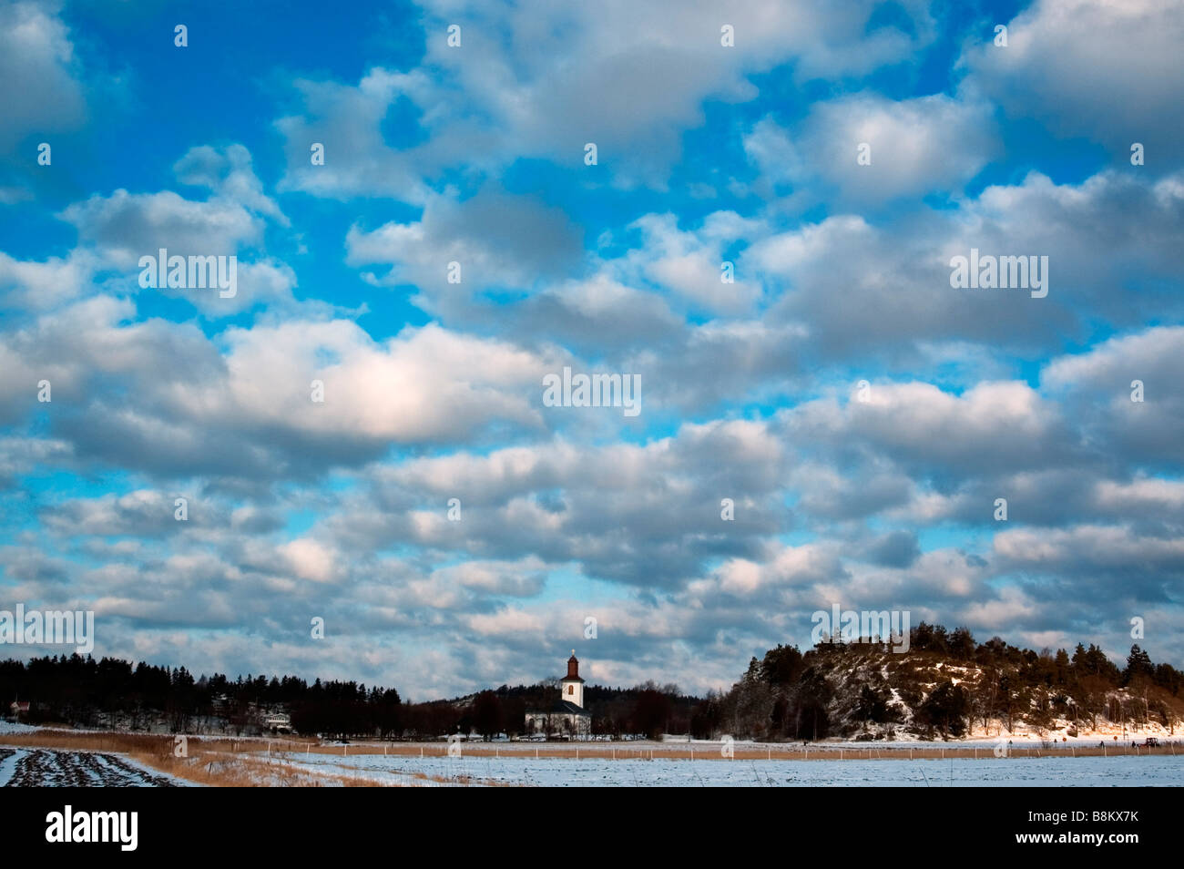 View in the countryside with a church Stock Photo - Alamy