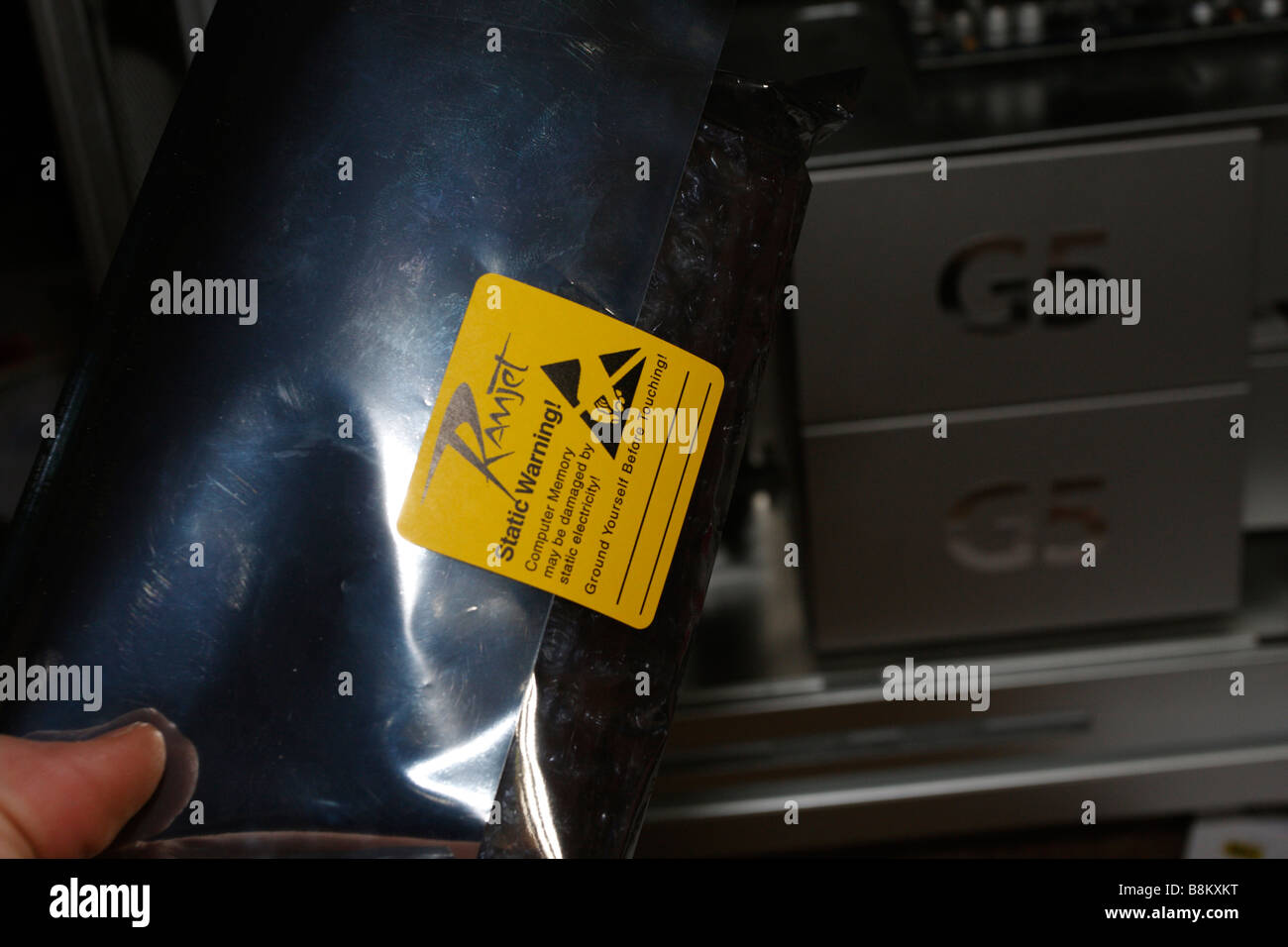 Ramjet antistatic sleeve in front of darkened Apple PowerMac G5, late 2004 dual 2gHz, side  open Stock Photo