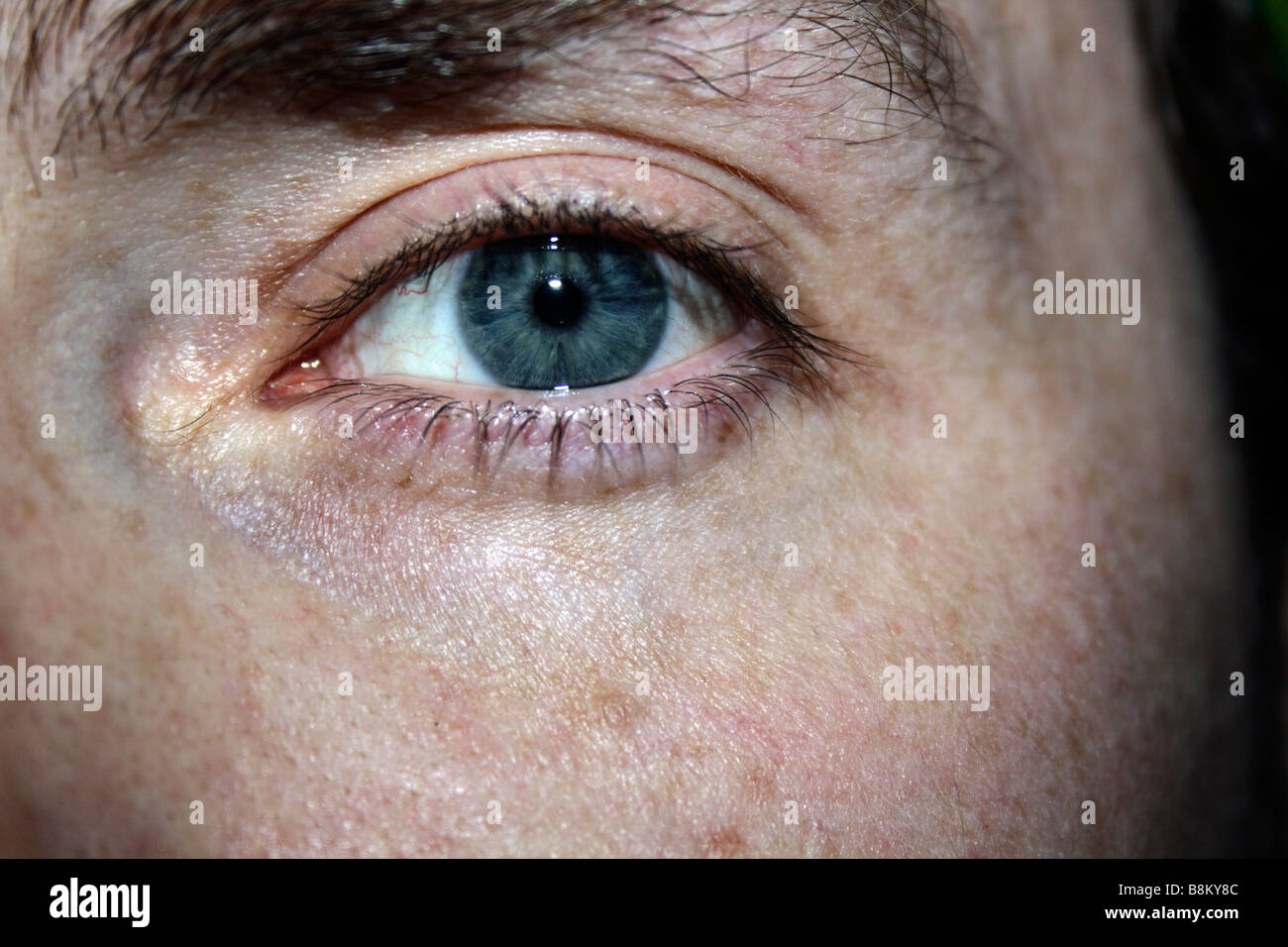 Male eye, open, aware conscious Blue Stock Photo