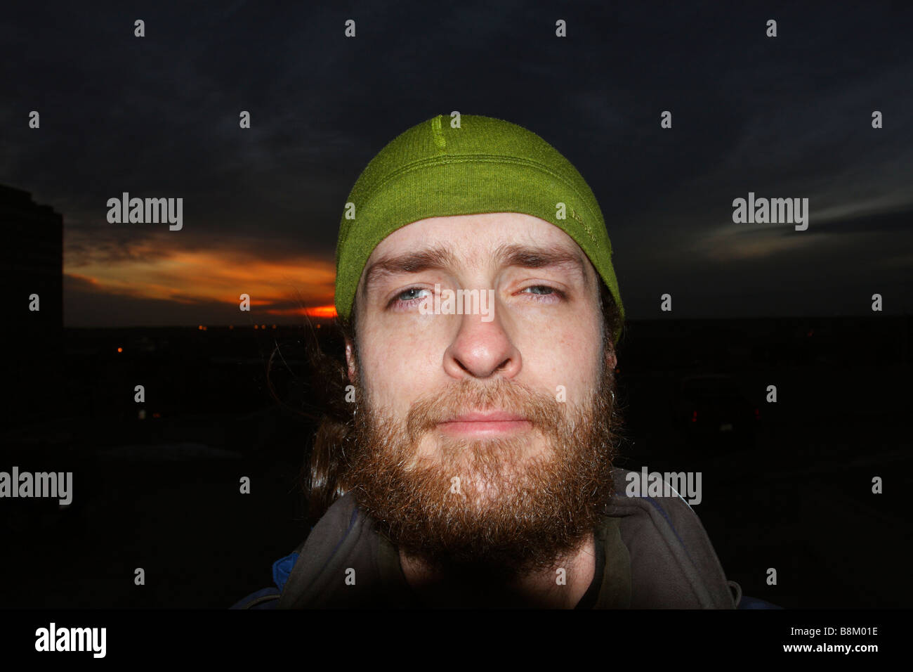 Man with beard wearing green patagonia hat. Stock Photo