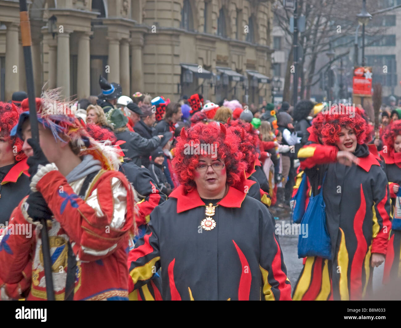 carnival Frankfurt on the Main at Kaiserplatz with women with red and black hairs and suits Stock Photo