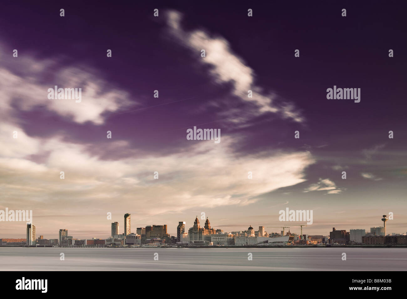 a long exposure image of the famous liverpool waterfront with a dramatic dark dawn or sunset with famous buildings Stock Photo