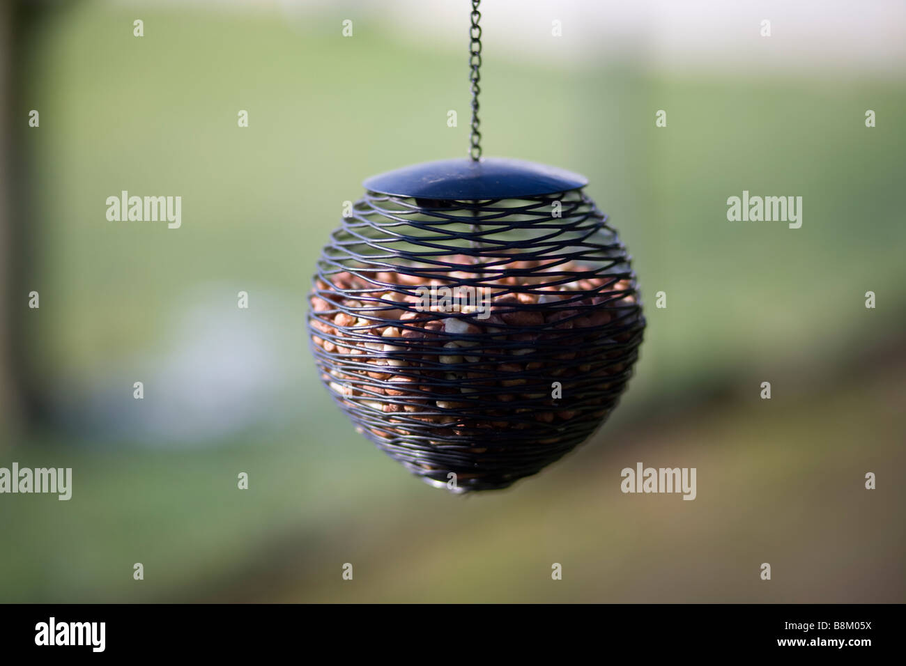 a bird feeder in an english country garden with blurred soft focus background Stock Photo Alamy