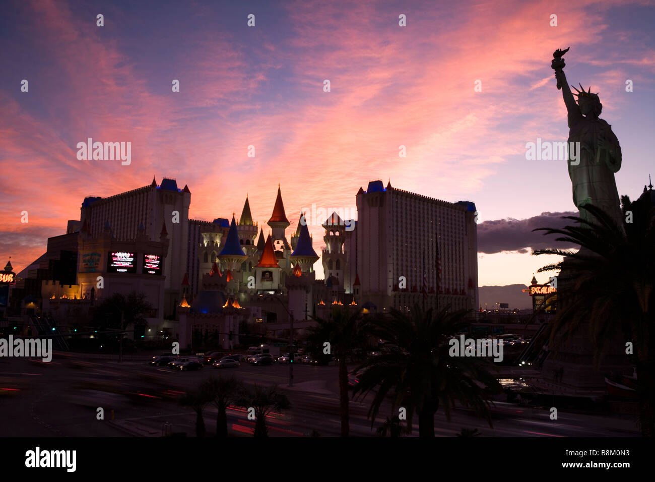 The Excalibur Hotel and casino and statue of liberty at sunset on the Las Vegas strip, Nevada, USA Stock Photo