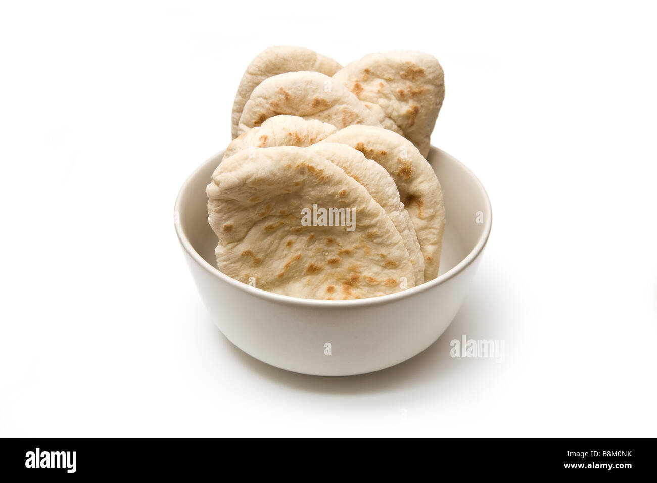 bowl of pita breads isolated on a white studio background Stock Photo