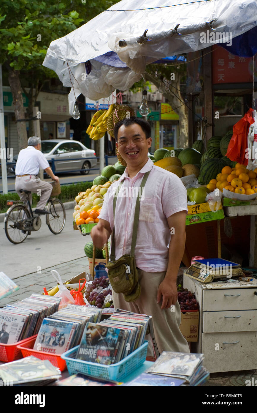 Street vendor in Shanghais french concession selling pirate DVD's. Stock Photo