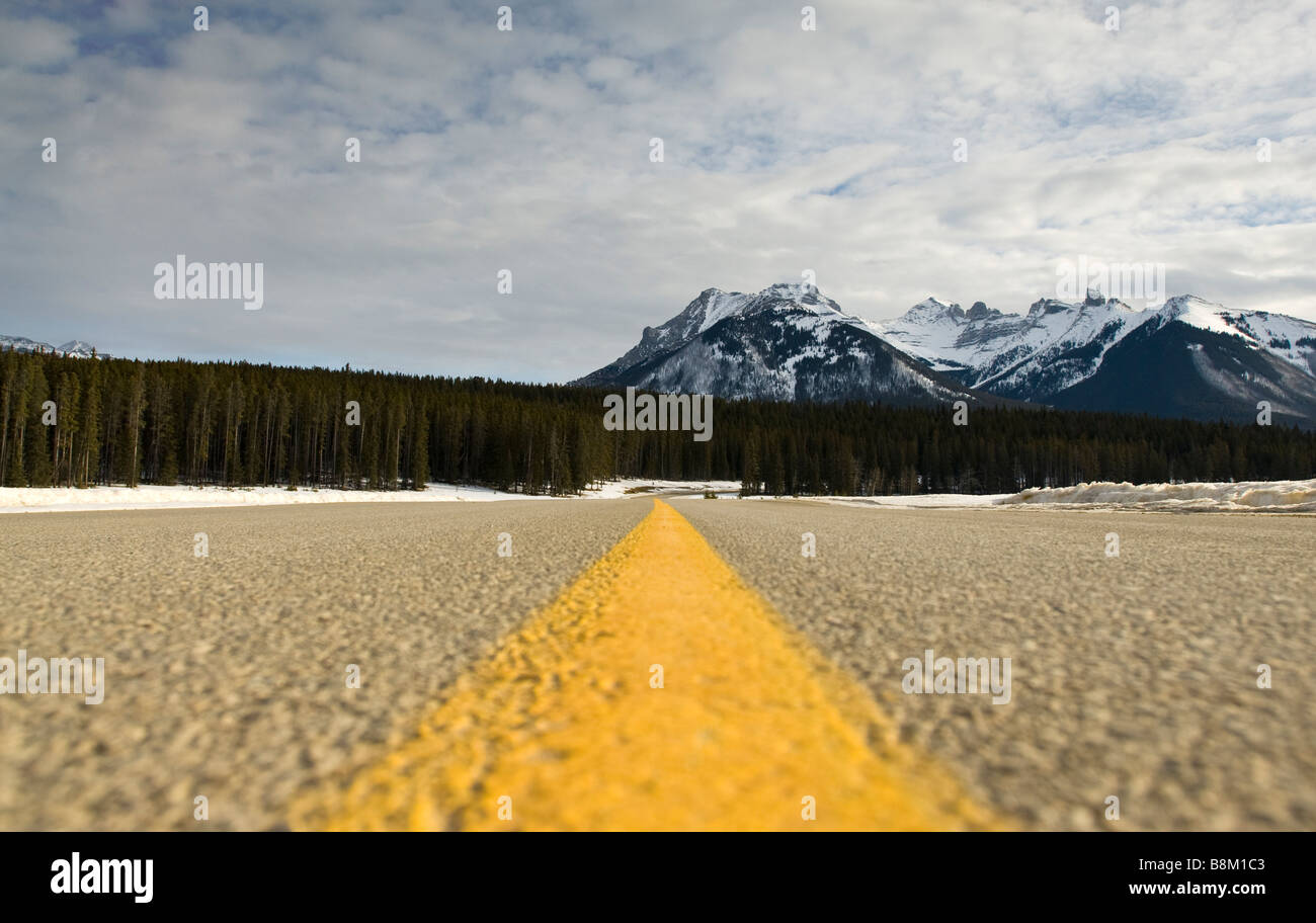 Yellow strip on a highway through Banff National Park in Alberta, Canada. Stock Photo