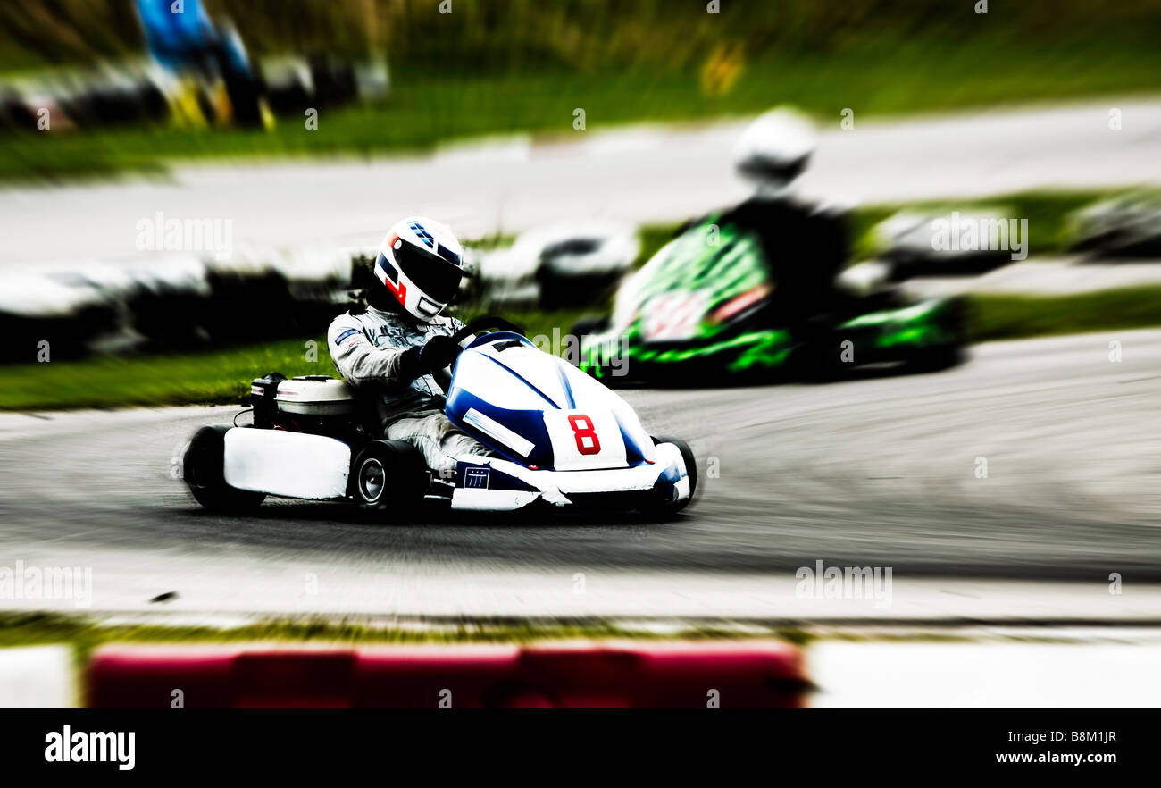 go kart racing on circuit Blurry Stock Photo