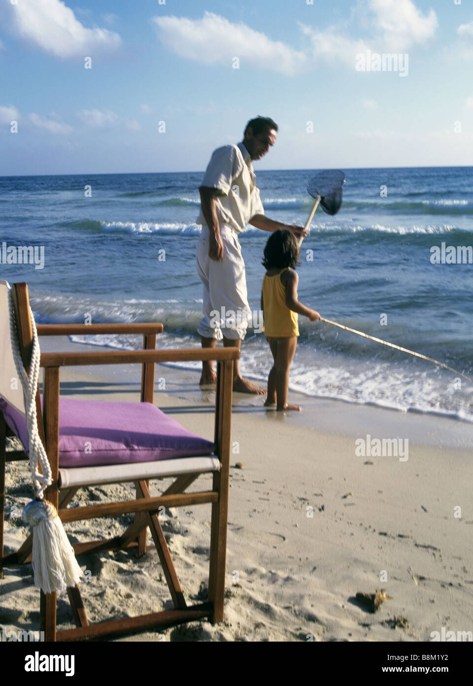 Father and son on the beach Stock Photo