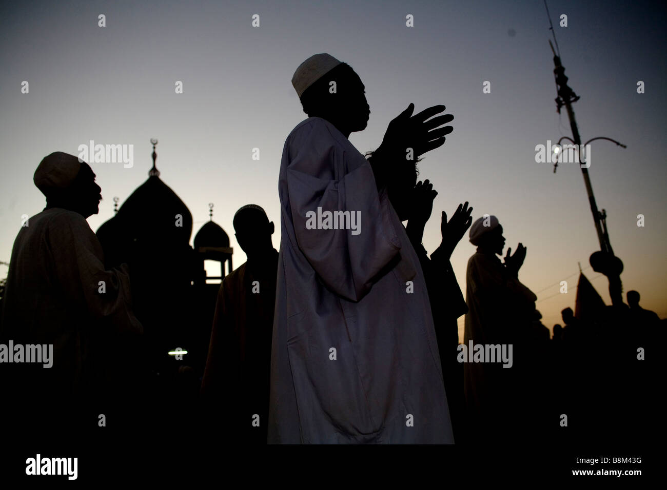 Praying at the end of Dervish dance ceremony at Hamed Al Nil tomb Ommdurman Khartoum Sudan Stock Photo