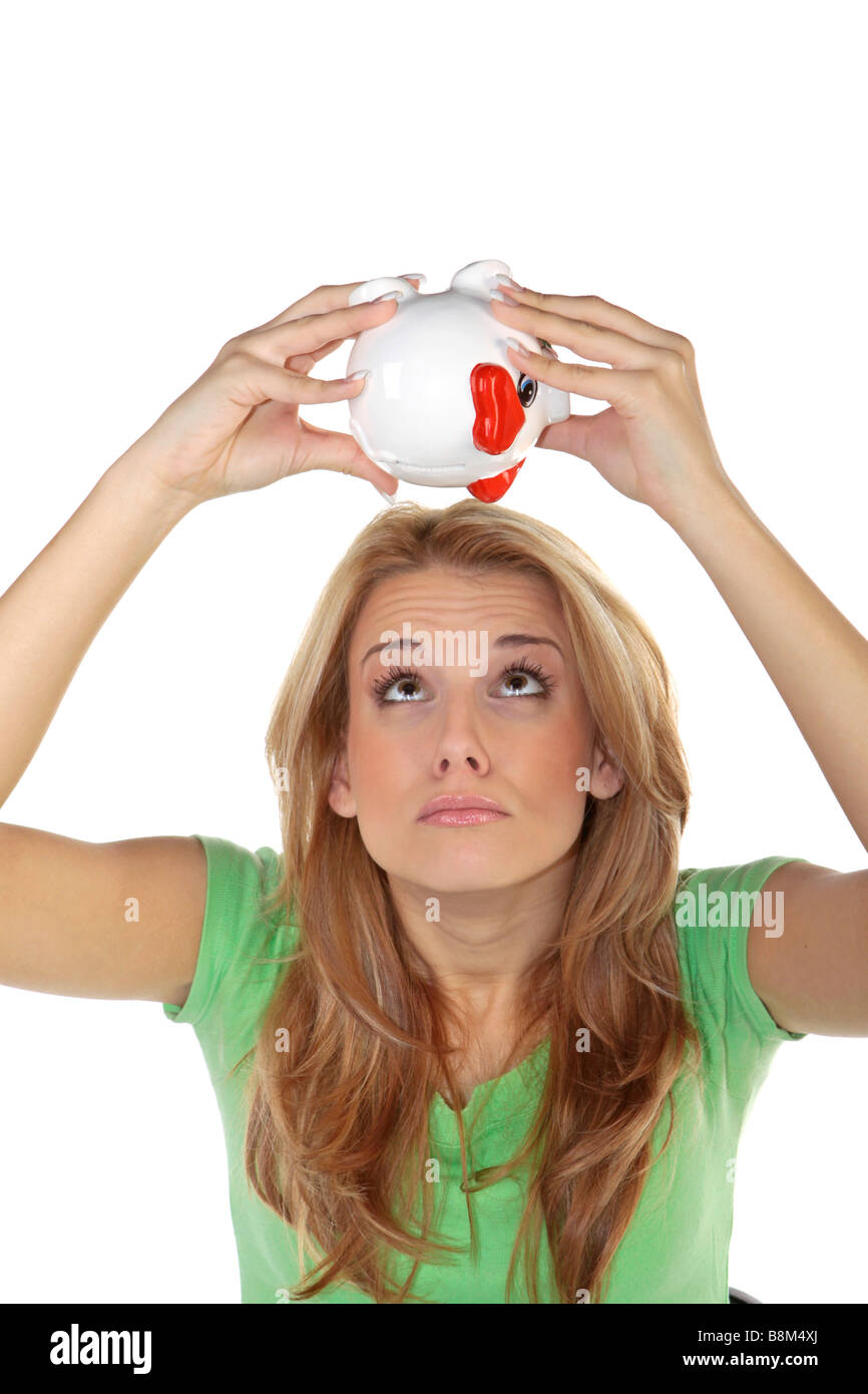 Unhappy young woman checking cash in empty piggy bank Stock Photo - Alamy