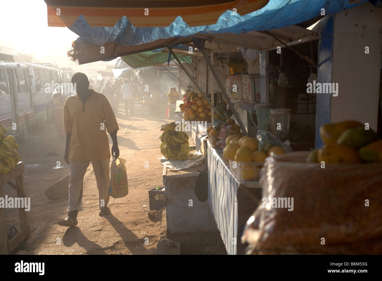 A customer walks by the shop at Ommdurman market, West Khartoum Stock Photo