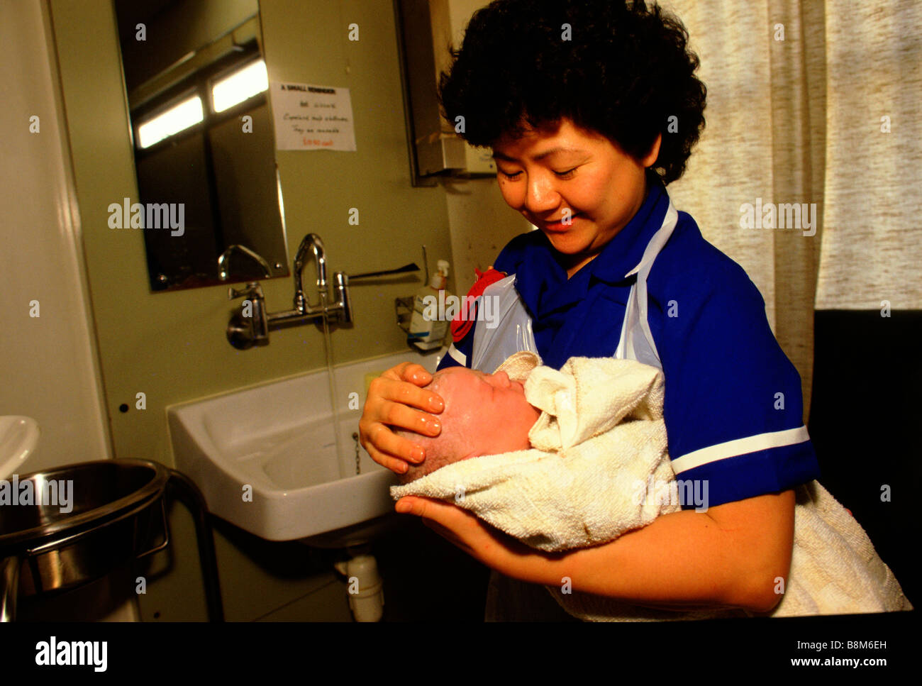 Whipps Cross Hospital London 1988 A nurse holds a newborn baby Stock Photo