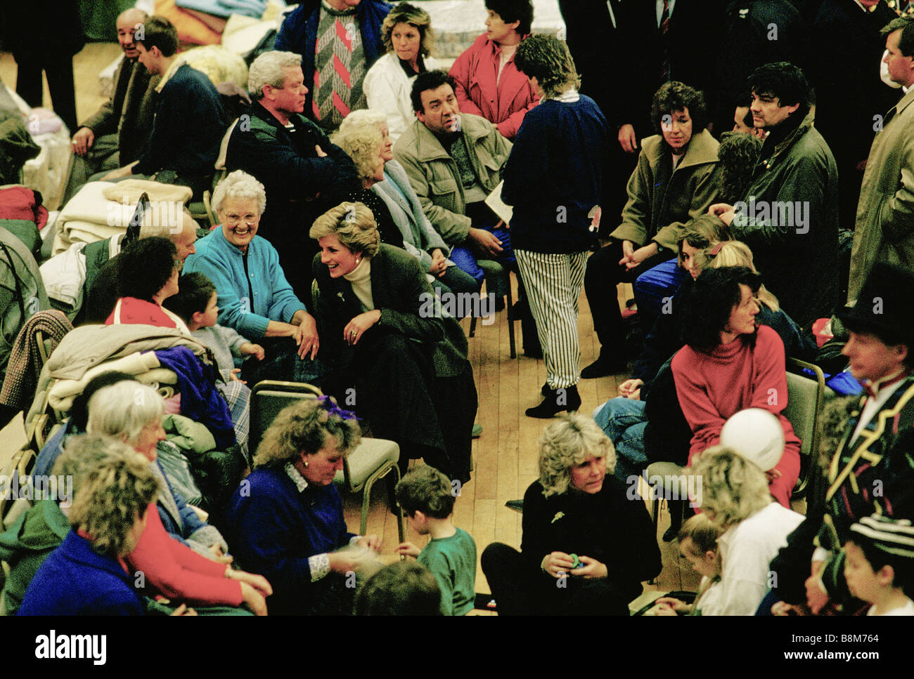 Towyn, Wales, February 1990: Hurricane winds cause the sea wall at Towyn to be break, flooding the north Wales coastal town.   Diana, Princess of Wales talks to displaced residents of the flooded town Towyn in a town hall. Stock Photo