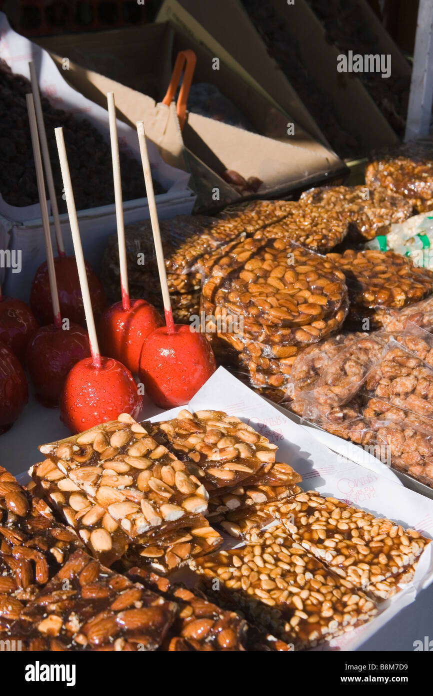 Toffee apples and caramelised nuts on sale at Spanish market Torrox Pueblo Axarquia Region Malaga Spain Stock Photo