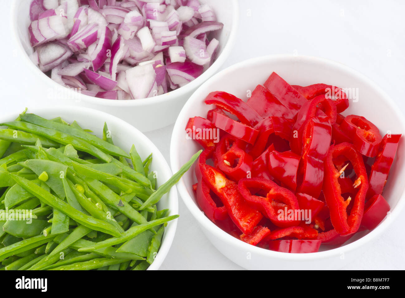 Fresh vegetables Diced peppers onion and mange tout Stock Photo Alamy