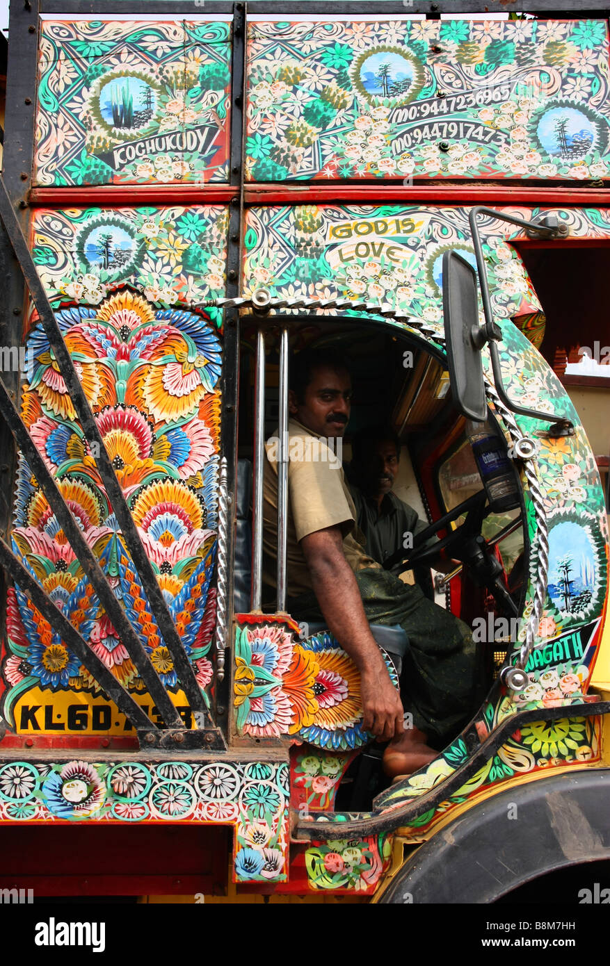Immaculately painted Tata truck with its slogan 'God is Love' and its drivers in Kararagod, Kerala, India Stock Photo