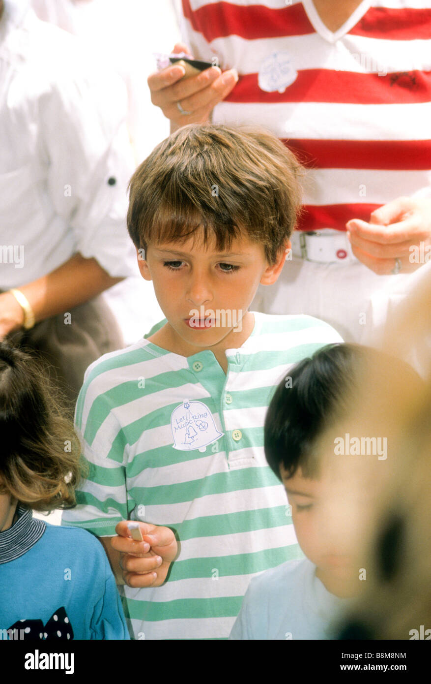 Young boy experiments with musical instruments at orchestra open house ...