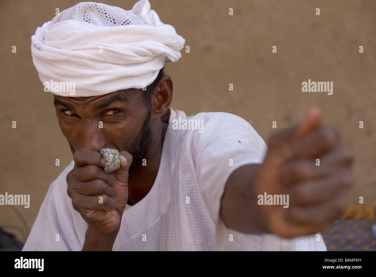 Nubian man posing with stone bowman ring in El-Ar at the 4th Nile River catharact region Nubia Sudan Africa Stock Photo