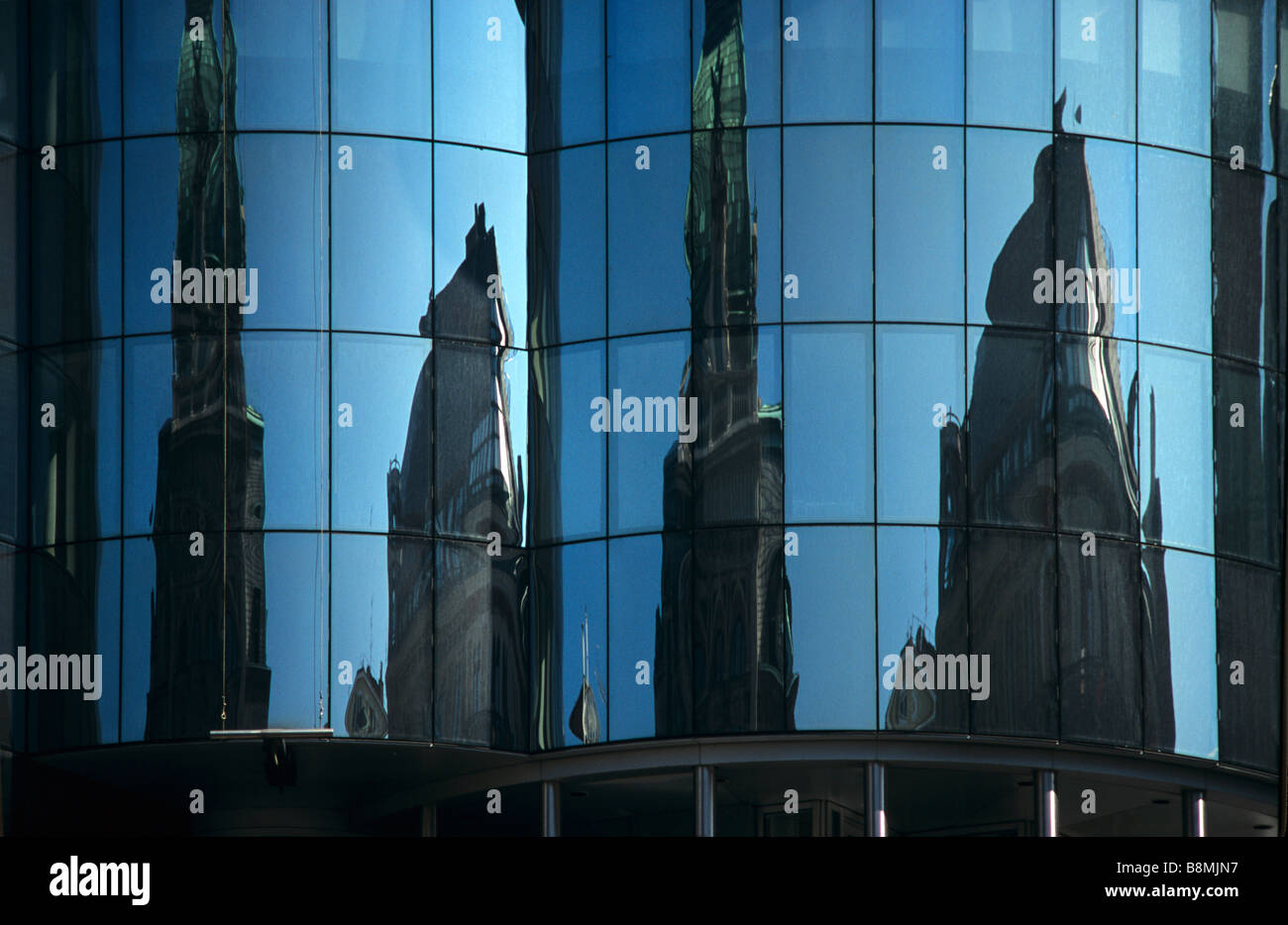 Spire of Saint Stephen's Cathedral Reflected in Windows of the Post-Modern Haas Haus (1987-90), by Hans Hollein, Vienna, Austria Stock Photo