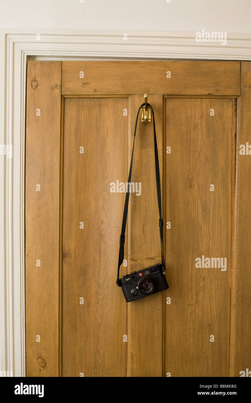 Leica camera hanging on back of a door Stock Photo
