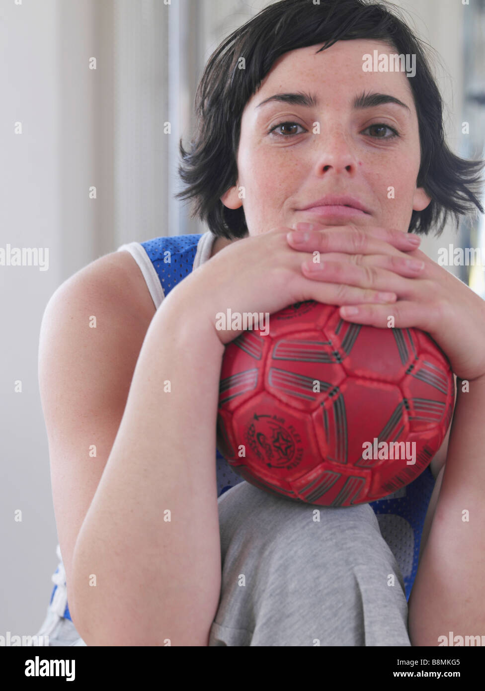 young woman with red ball Stock Photo Alamy