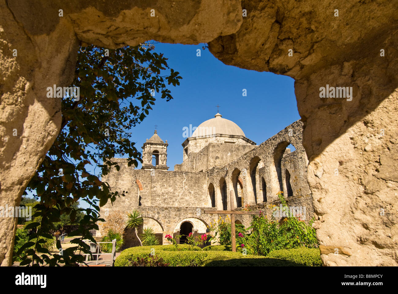 Mission San Jose view through thick stone walls to domed mission church Missions National Park Texas TX Stock Photo