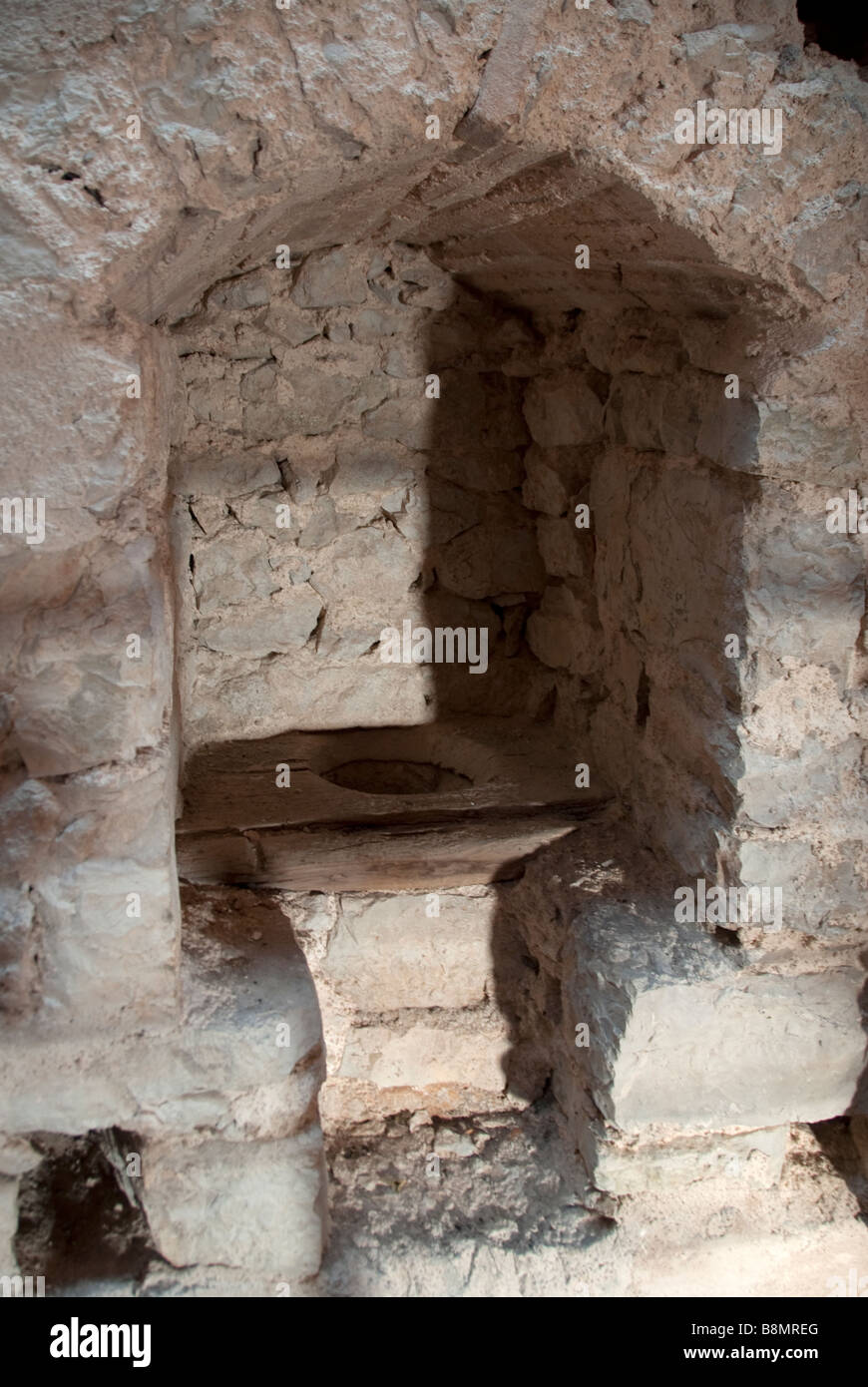Original latrine or toilet in The Castle of Pissignano founded in the in the 11th Century near Clitunno Stock Photo