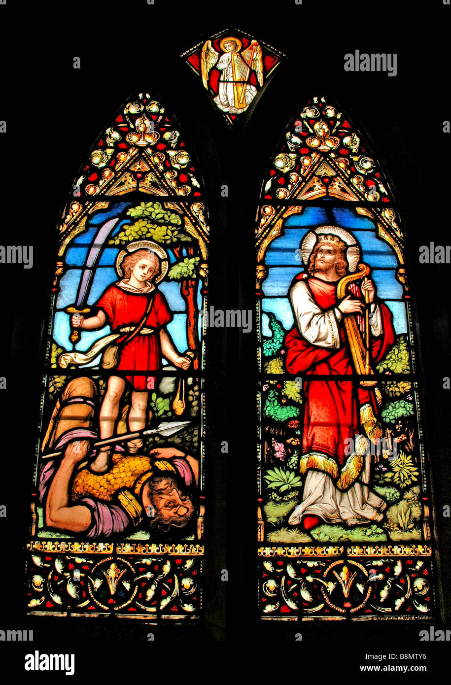 Church stain glass windows depicting scenes from the life of King David. Stock Photo