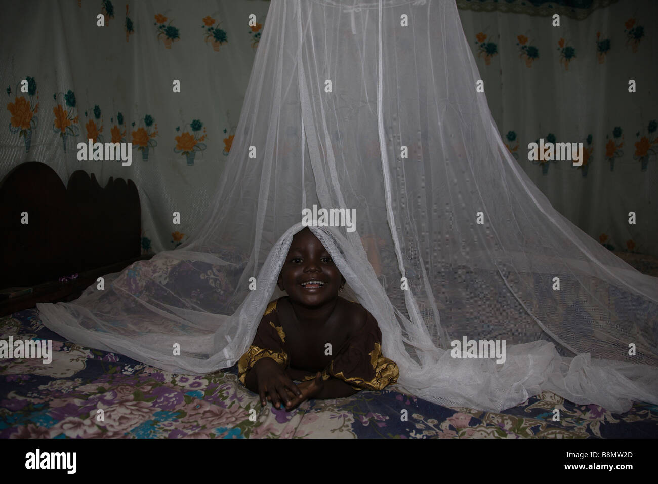 A child in Nigeria sleeps under a long lasting insecticide treated