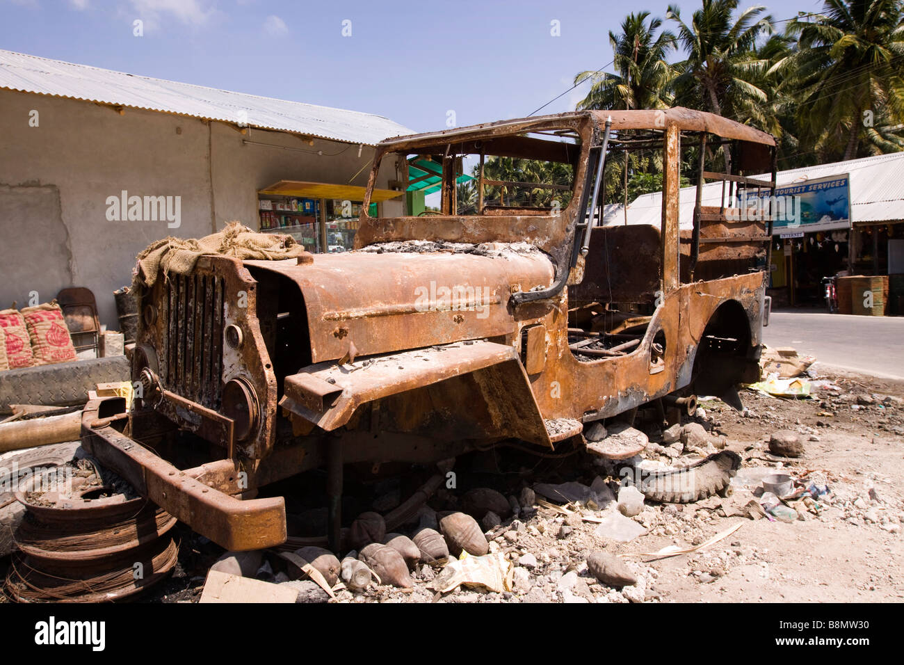 India Andaman and Nicobar Havelock island number 3 village bazaar burned out vehicle after fire Stock Photo