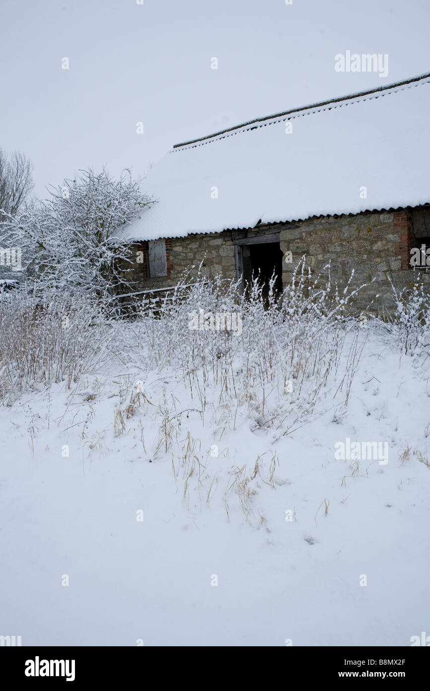 tumbledown cottage in the snow Stock Photo