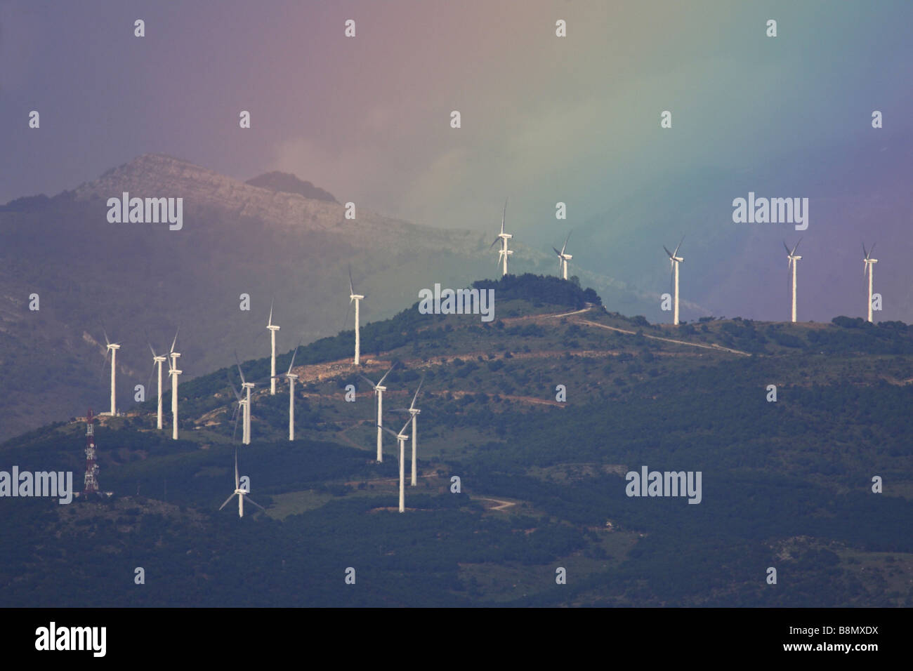 windmills with rainbow in the Kerkini Moutains, Greece Stock Photo