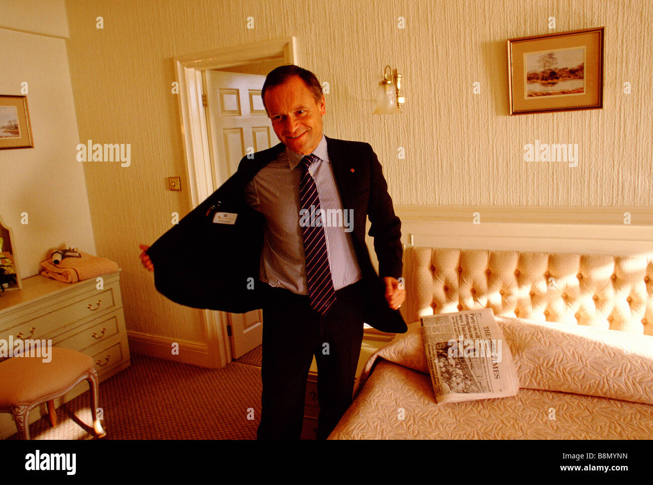 Jeffrey Archer author and ex deputy of the Conservative Party takes off his jacket having just arrived at a golfing hotel Stock Photo